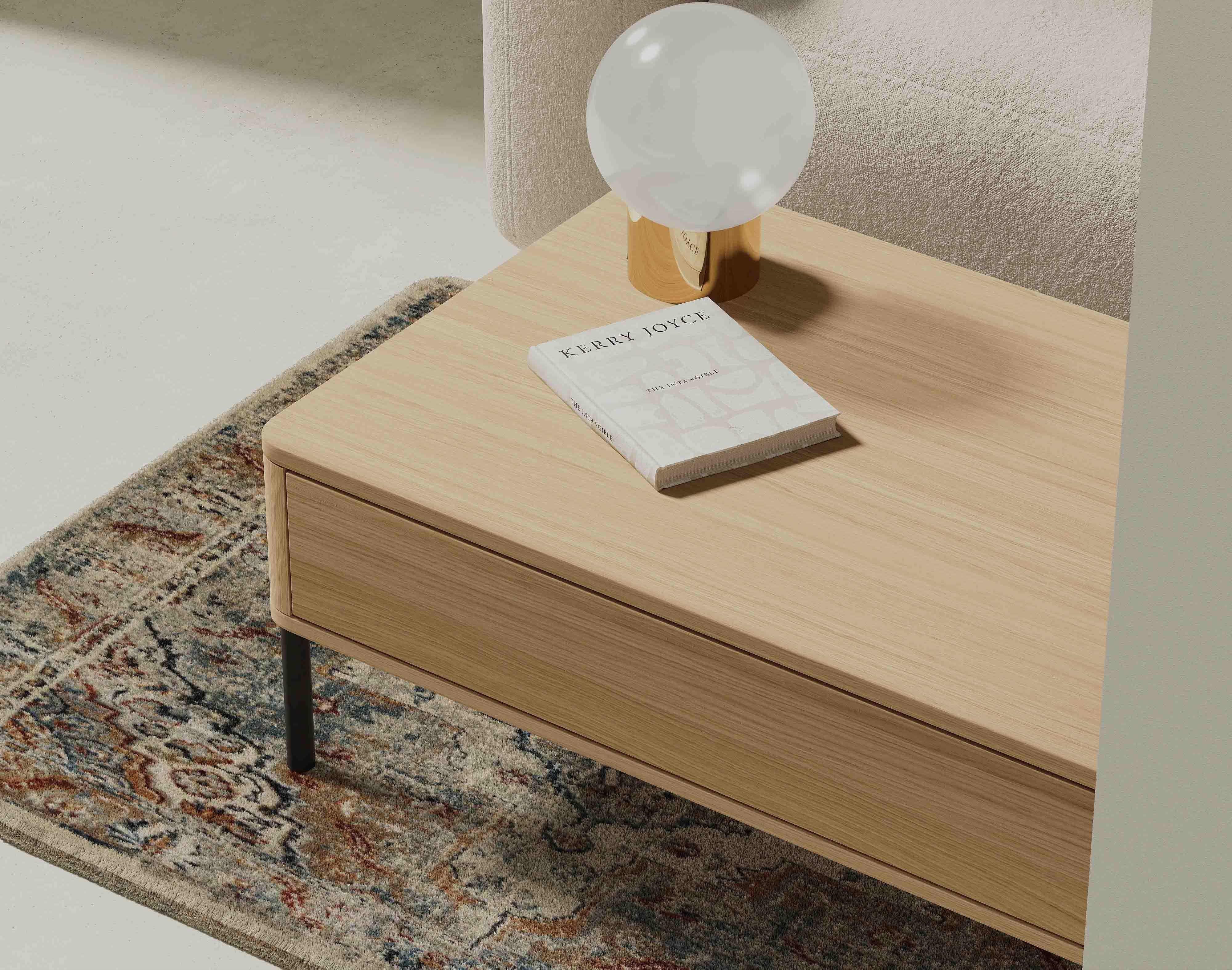 Wooden oak coffee table with a decorative lamp and book in a living room setting